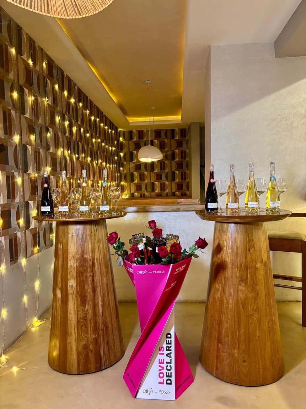 Wine glasses and roses on tall tables