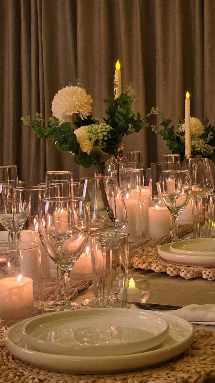 Candlelit table set with flowers