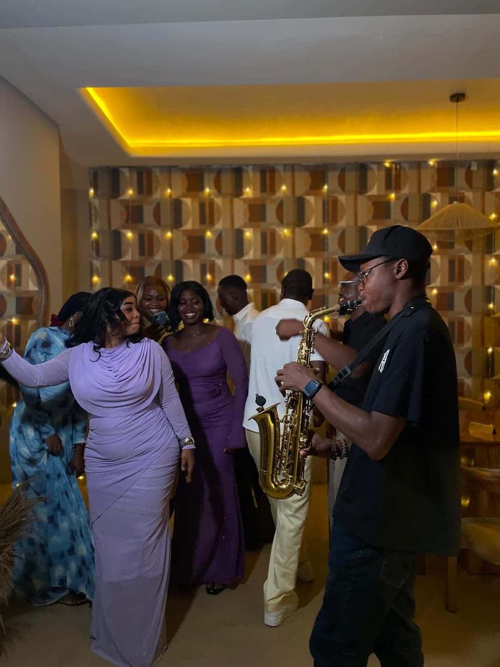 Guests dancing with saxophonist