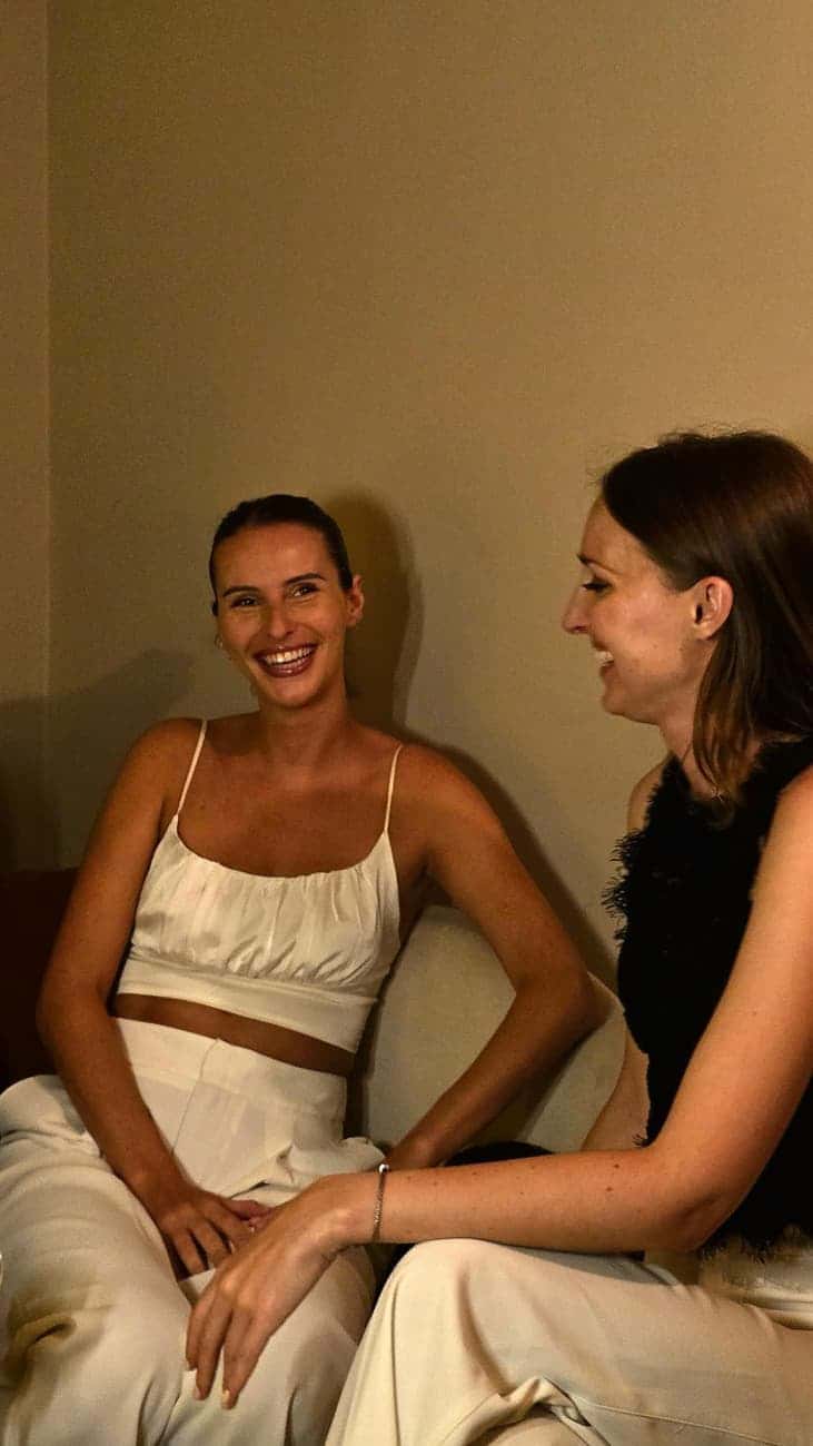 Two smiling guests at evening event