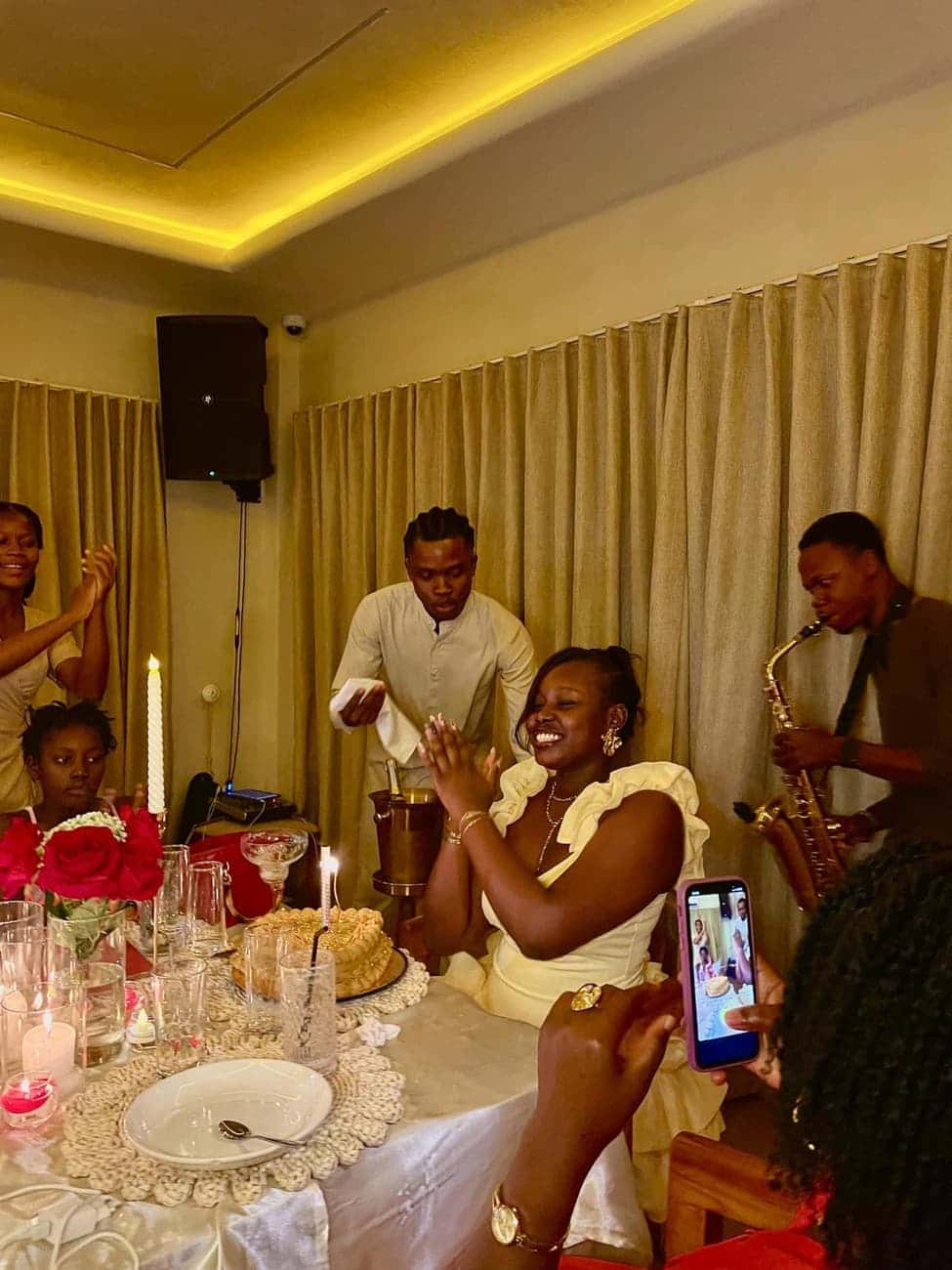 Guests applaud with saxophonist at dinner