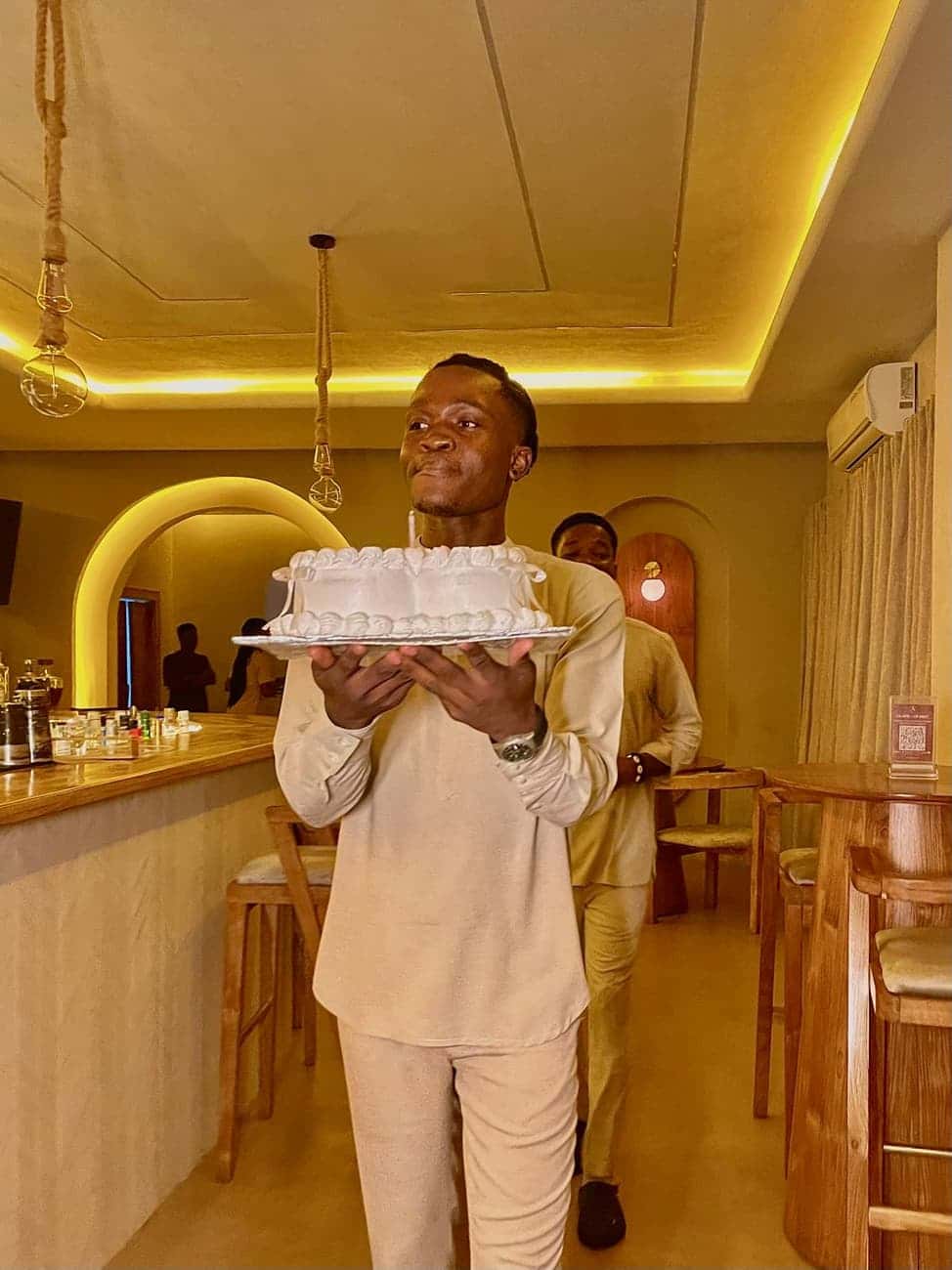 Server carrying a cake near the bar