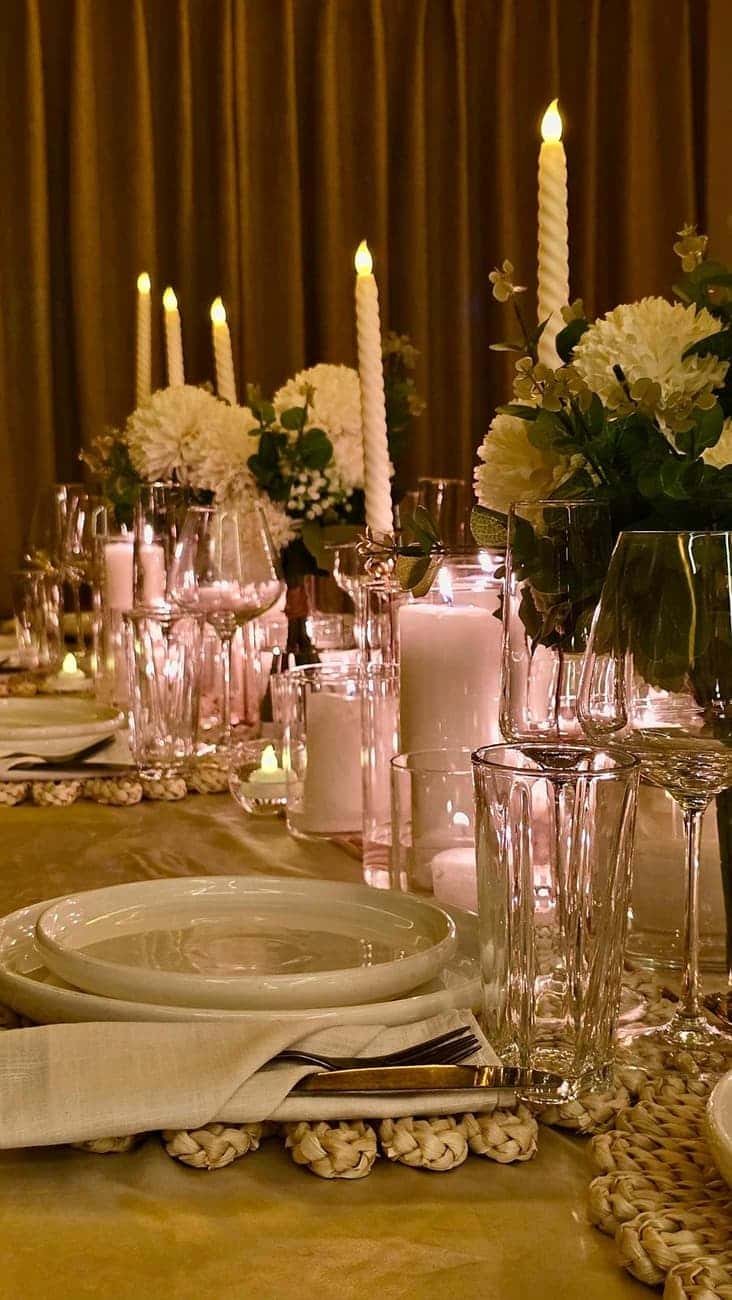 Candlelit table set with white flowers