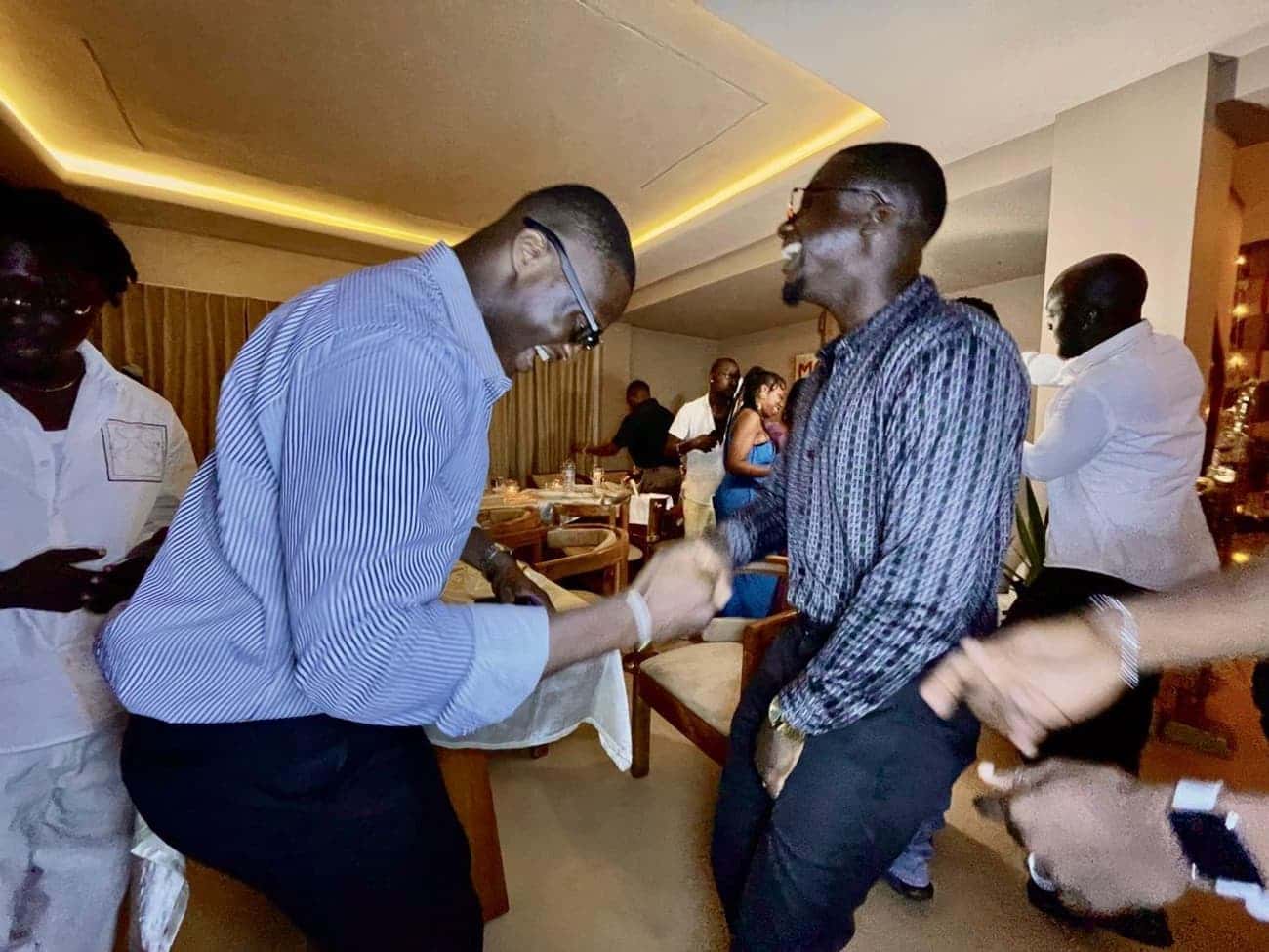 Two men dancing at a party