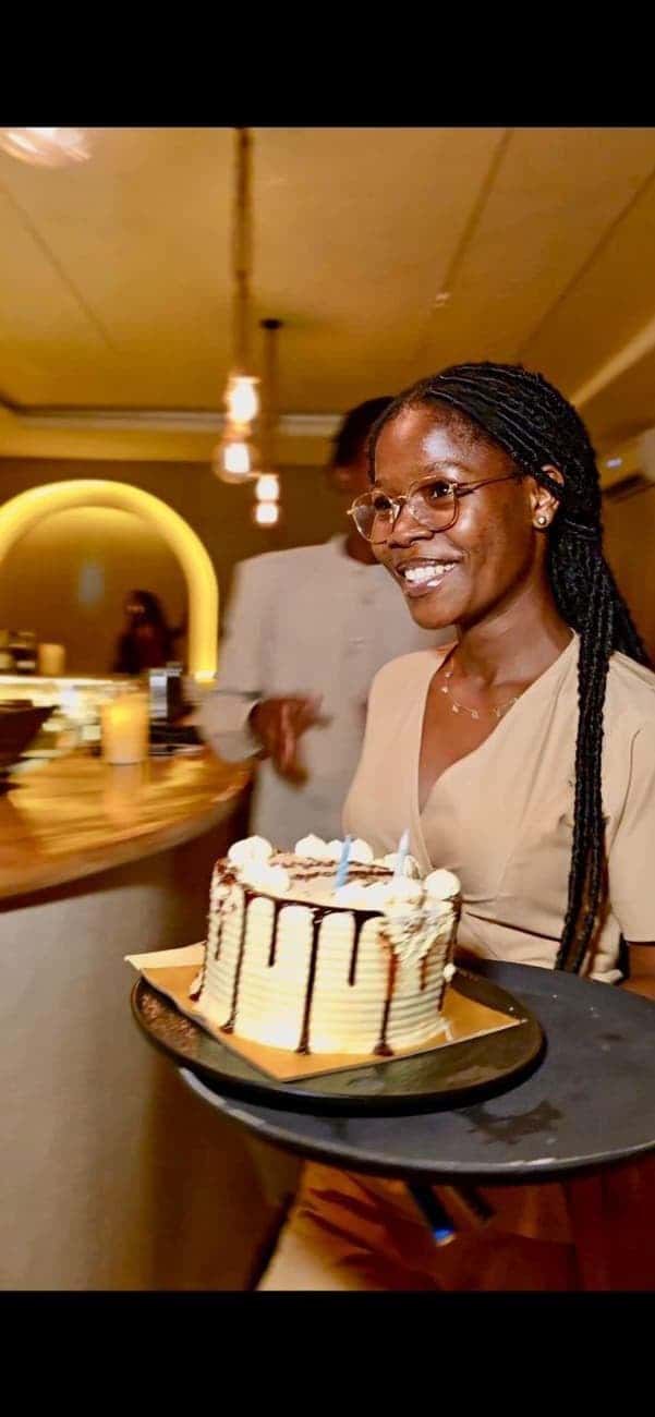 Waitress presenting a birthday cake