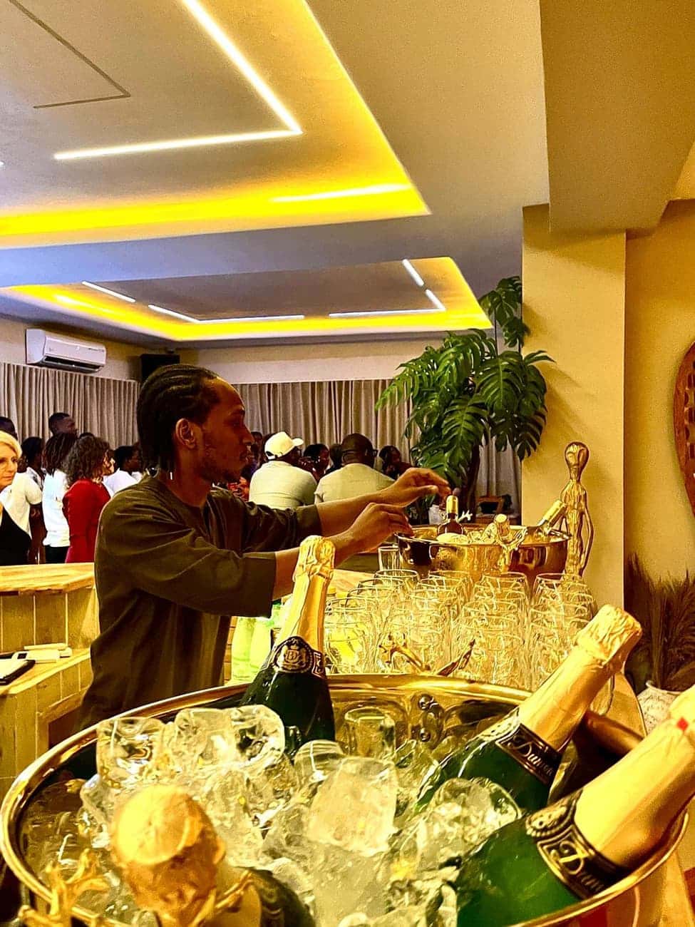 Server arranging champagne at a party